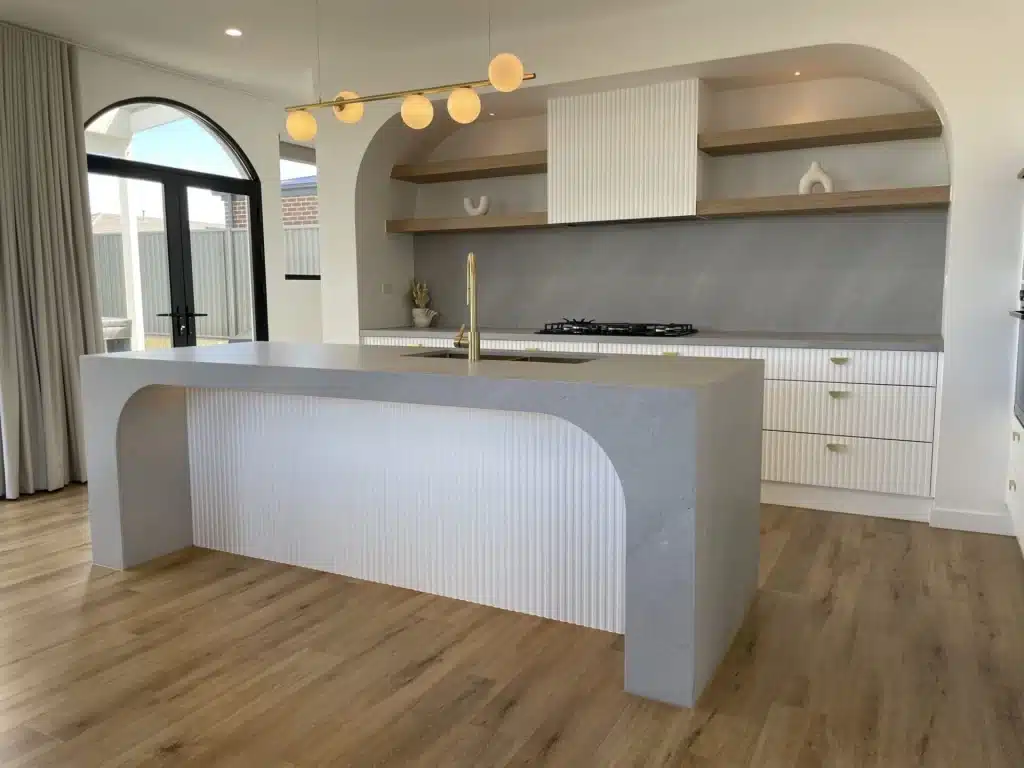 curved waterfall paired with muted timber cabinetry